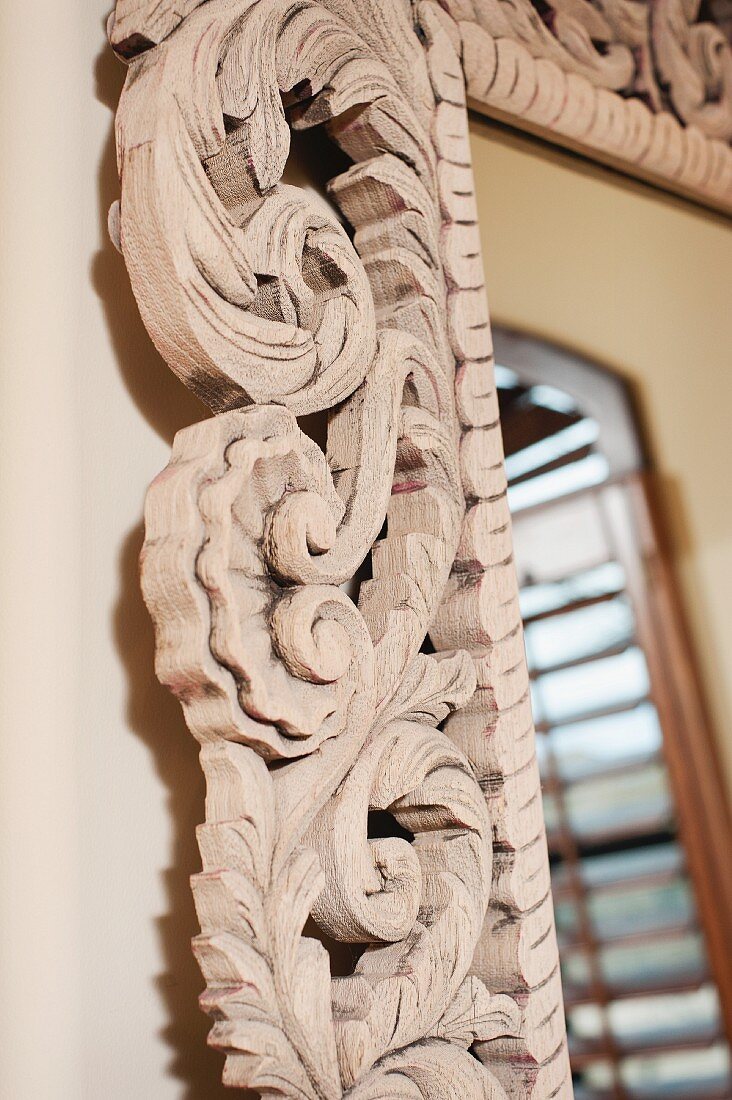 Detail of designs on wood-framed mirror on wall; Scottsdale; USA