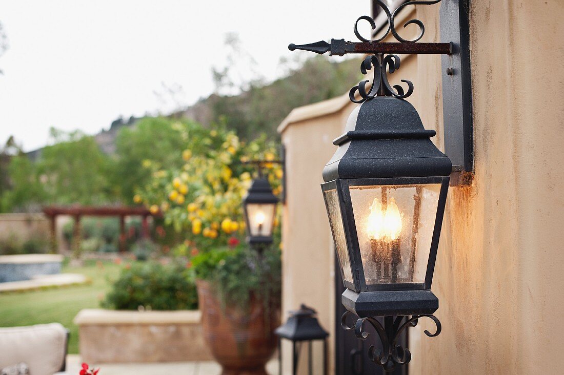 Close-up of a lit lantern mounted on wall; Rancho Sante Fe; USA