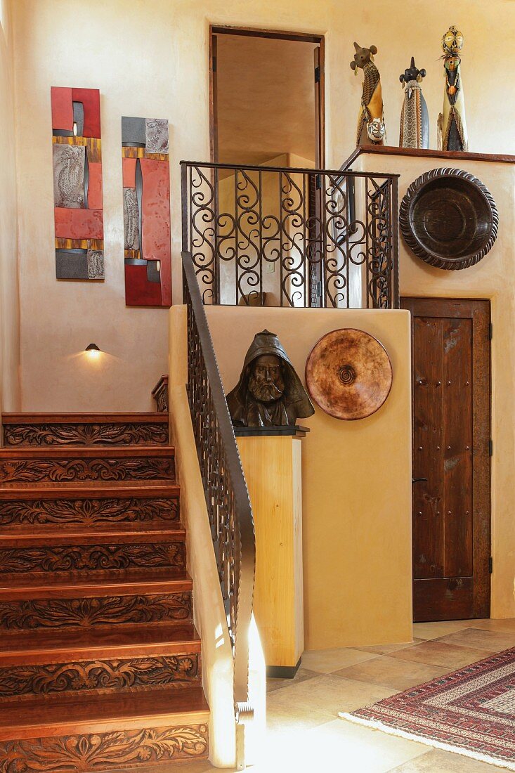 Antique bust next to steps in traditional house; Santa Fe; New Mexico; USA