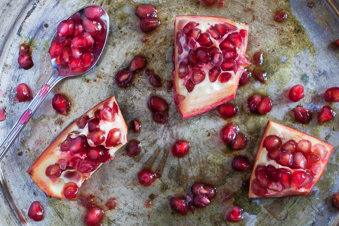 Sliced pomegranate on a silver tray