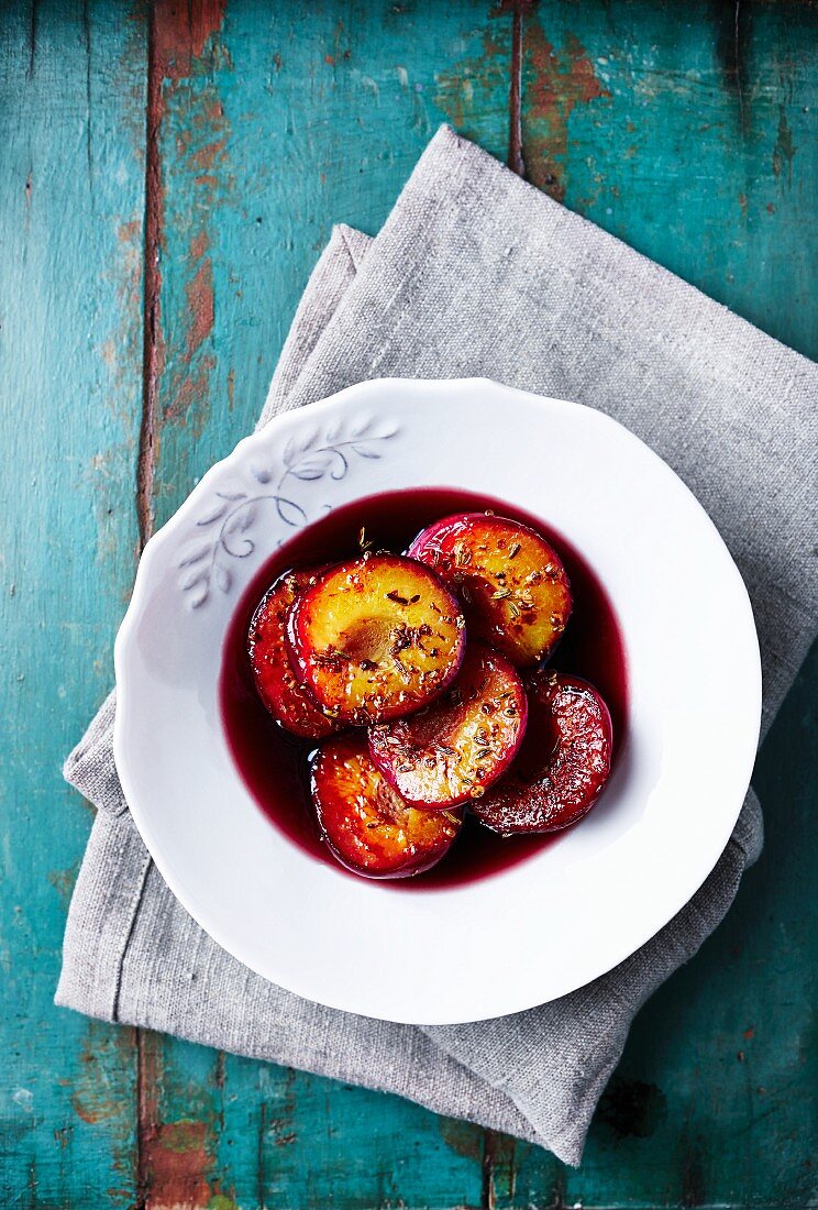 Baked plums with spices in a red wine sauce