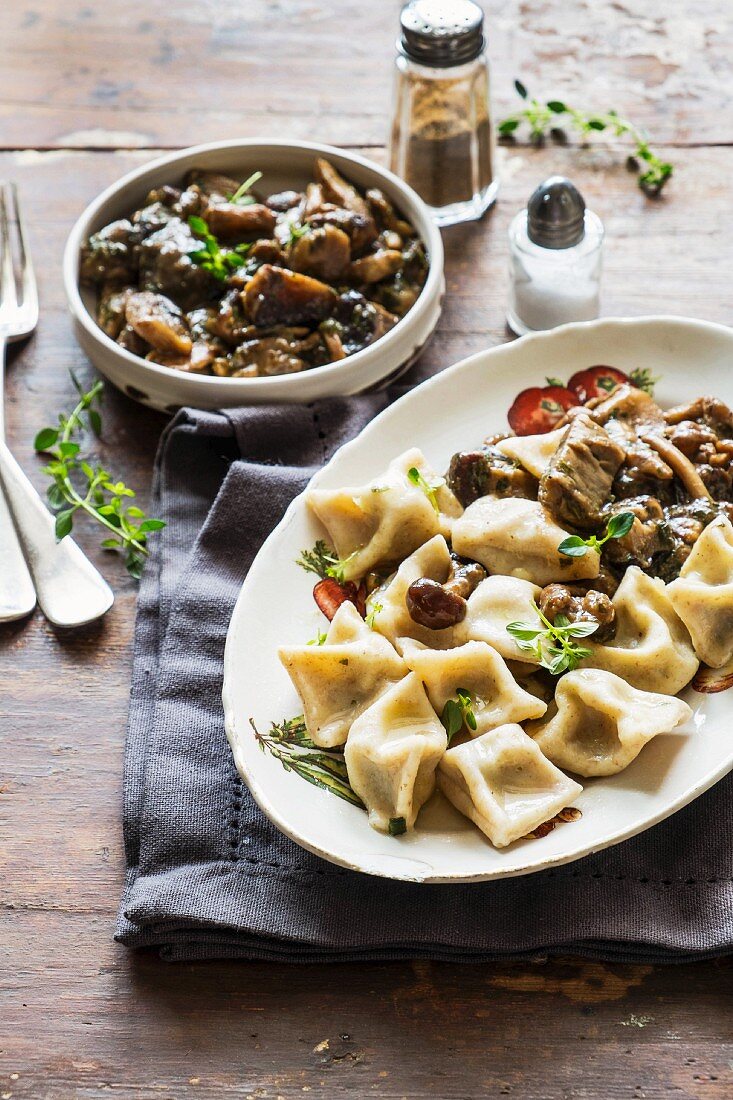 Pastry parcels filled with potatoes served with a mushroom sauce