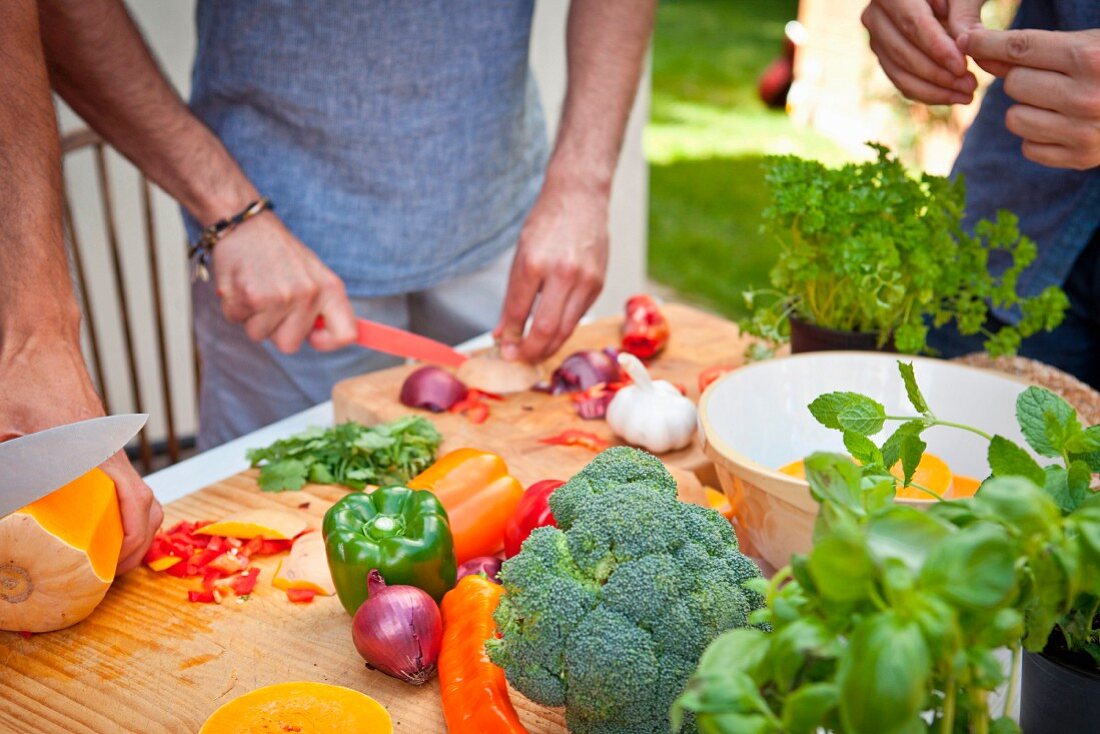 Vegetables being prepared on a garden table for grilling