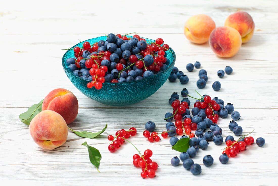 An arrangement of blueberries, redcurrants and peaches