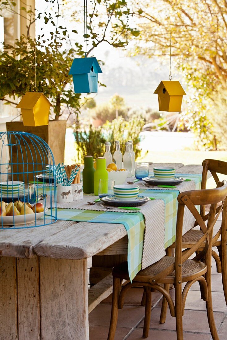 Bird houses hung over set table