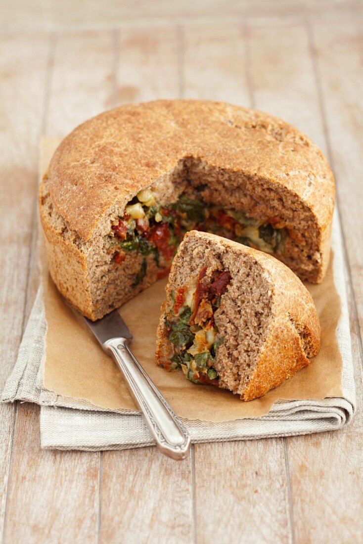 Wholemeal bread filled with spinach, feta cheese and dried tomatoes