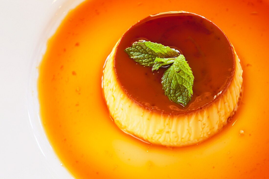 Creme caramel garnished with mint leaves