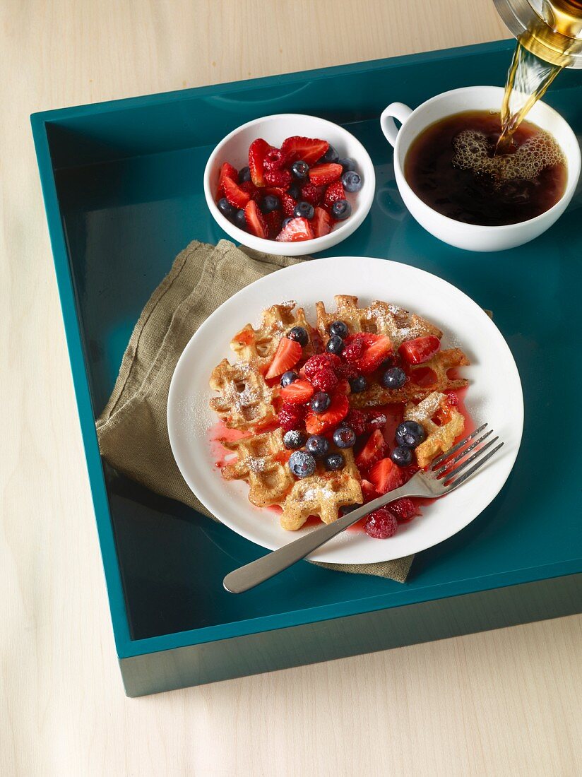 Waffles with blueberries, strawberries and coffee