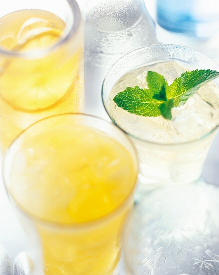 Summer cocktails made with lemon juice, ice cubes and mint