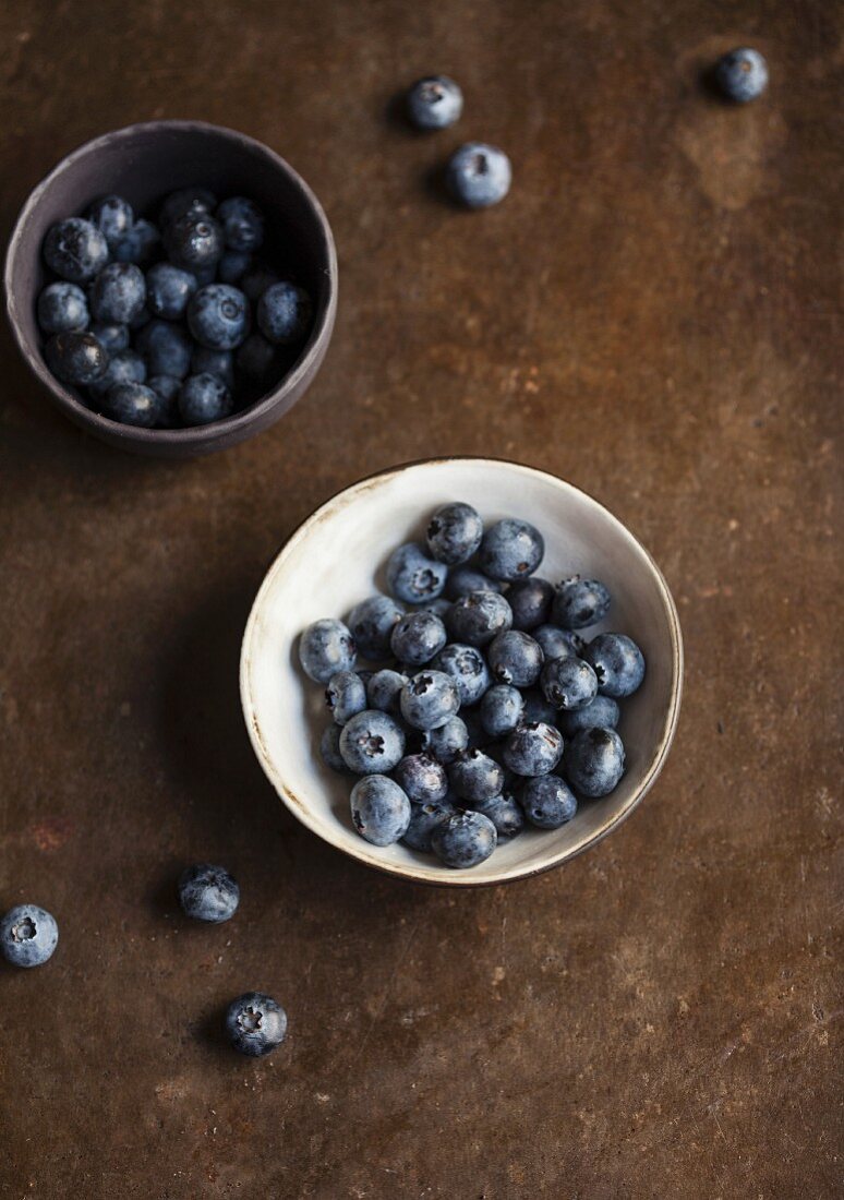 Two bowls of fresh blueberries