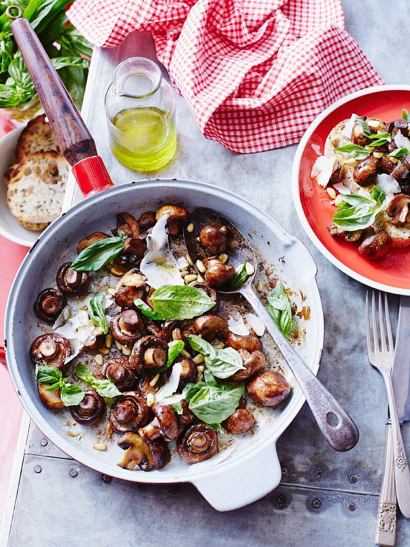 Fried mushrooms with basil pesto in a pan