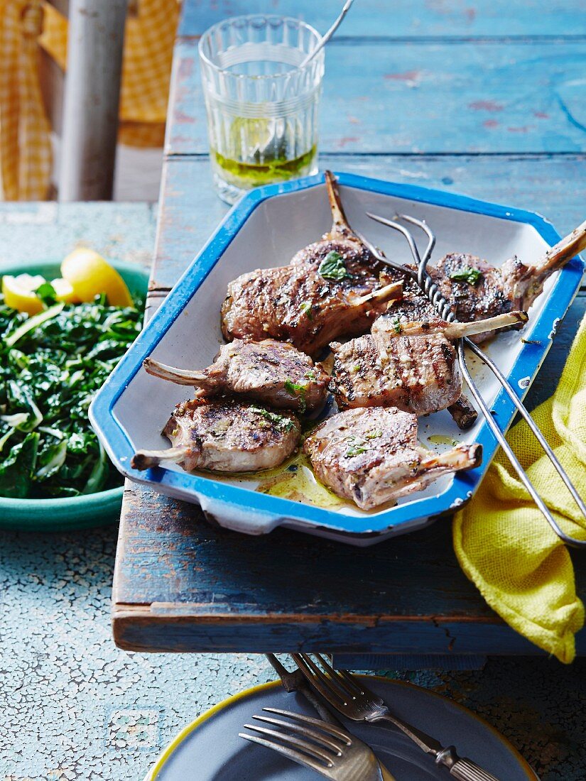 Lamb chops with lemon and mint in a ceramic dish