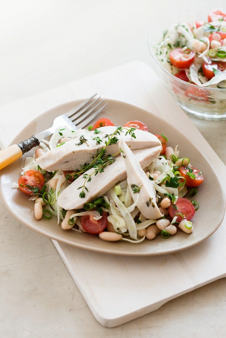 Chicken breast en papillote on a vegetable salad