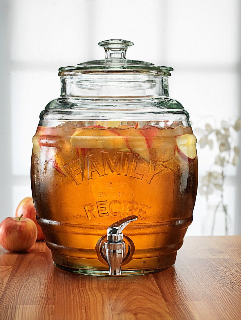 Apple spritzer in a glass barrel with a tap