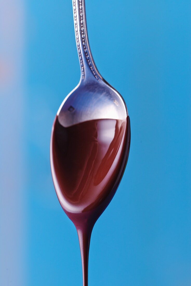 Liquid chocolate dripping from a spoon