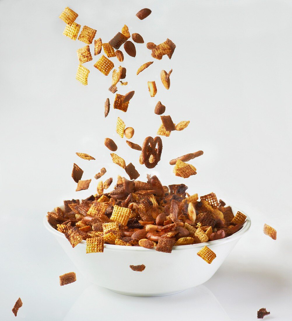 Snacks falling into a bowl