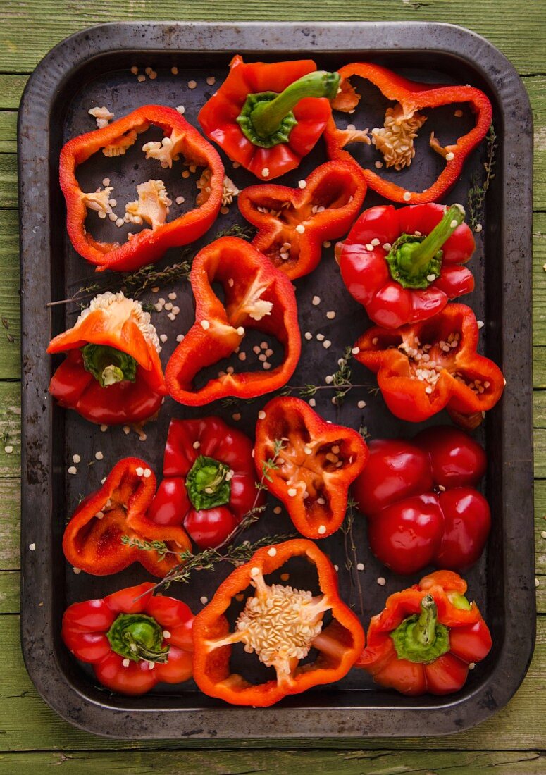 Sliced red peppers on a baking tray