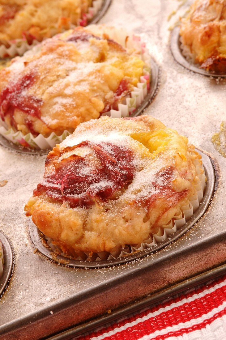 Rhubarb pudding cakes in a muffin tin