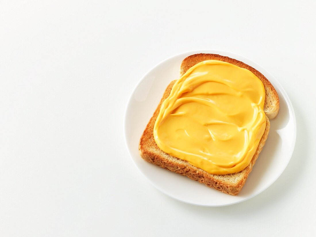 Slice of bread topped with spreadable cheese