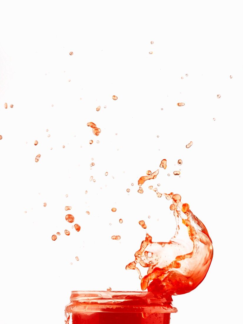 Red juice splashing from a glass