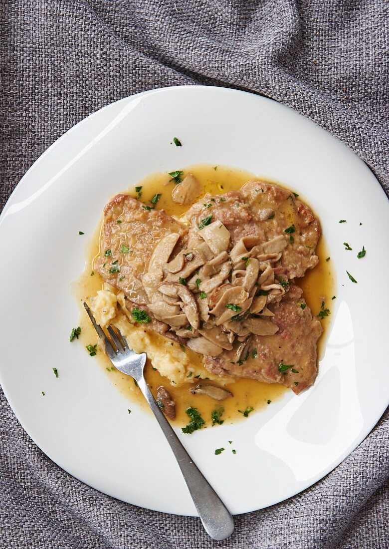 Veal escalope with mushroom sauce on a bed of mashed potatoes