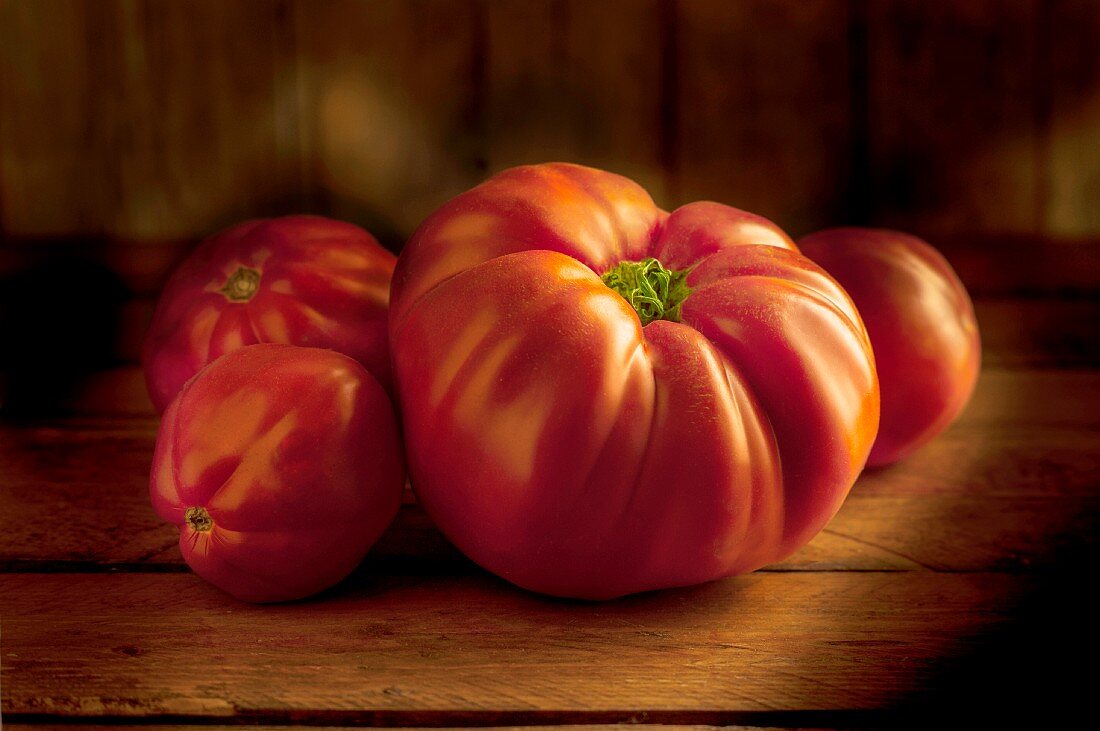 Beefsteak tomatoes on a wooden surface