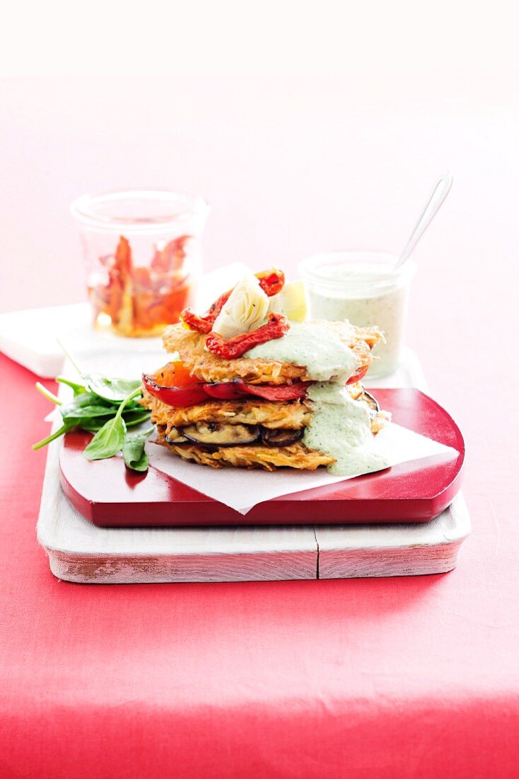 Potato cakes with antipasti vegetables