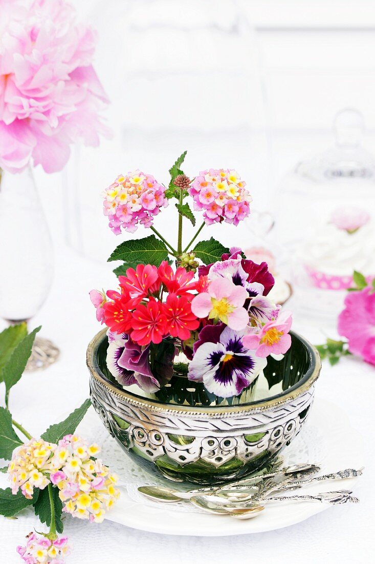 Arrangement of Lantana, violas, Lewisia & strawberry flowers