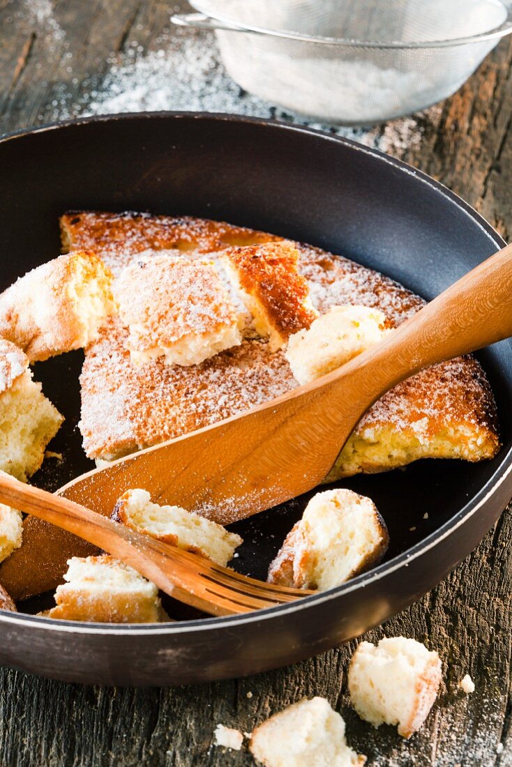 Kaiserschmarren (shredded sugared pancake from Austria) being shredded