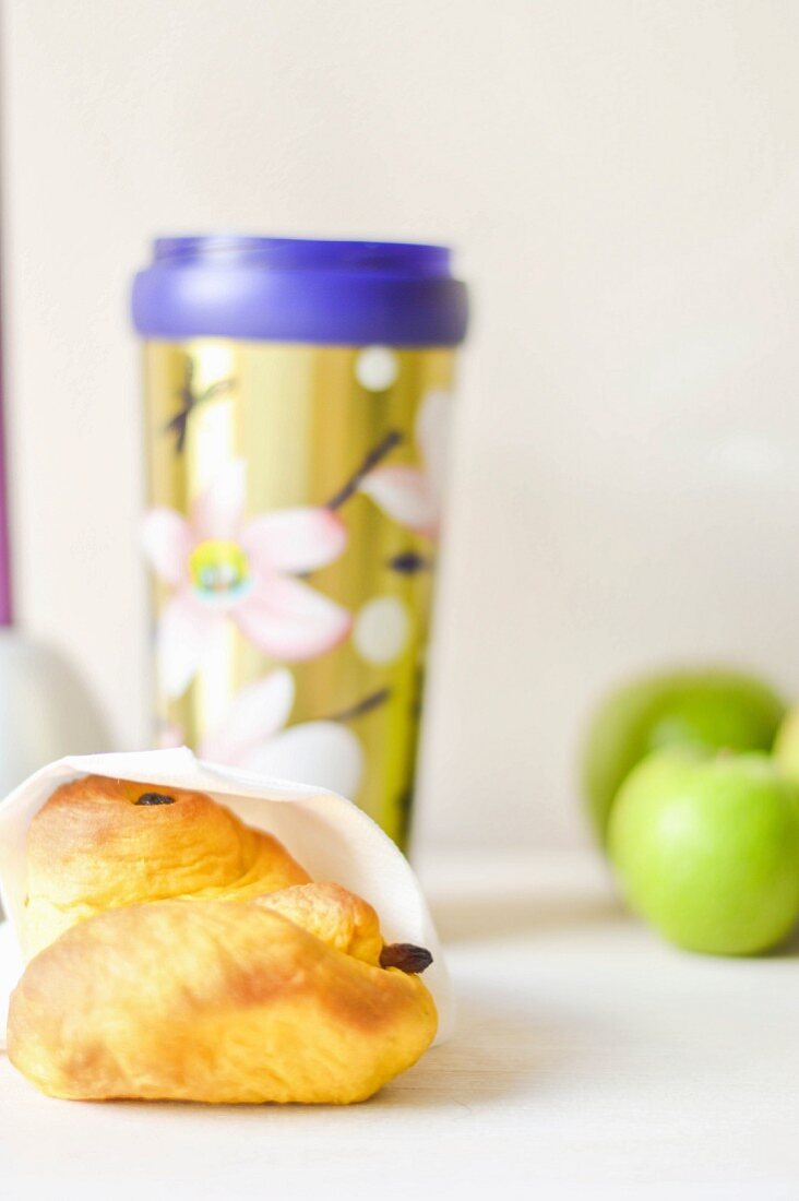 A breakfast pastry and tea to go