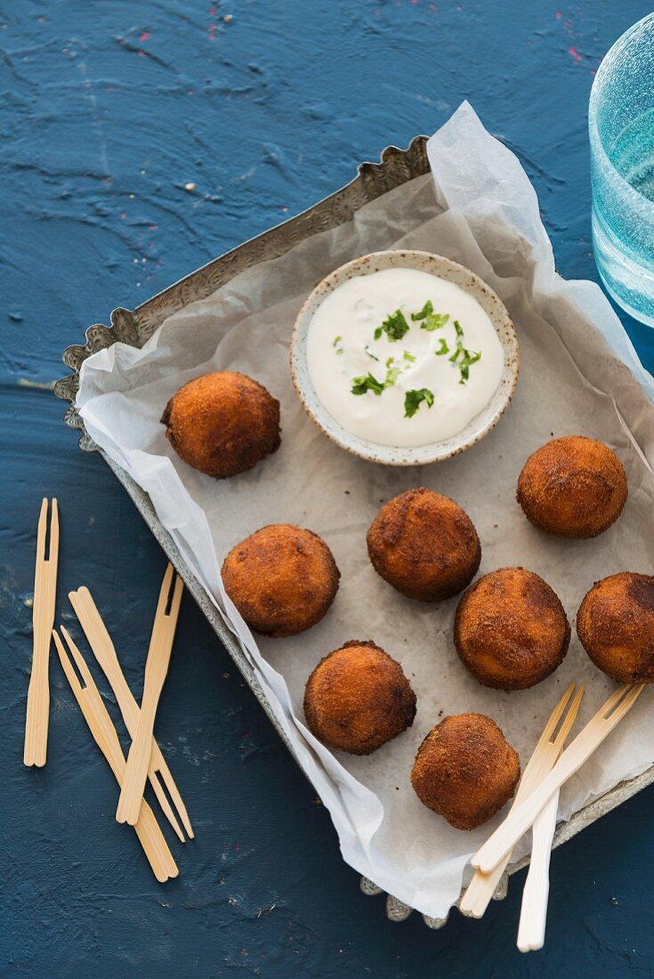 Deep-fried cheese balls with a dip