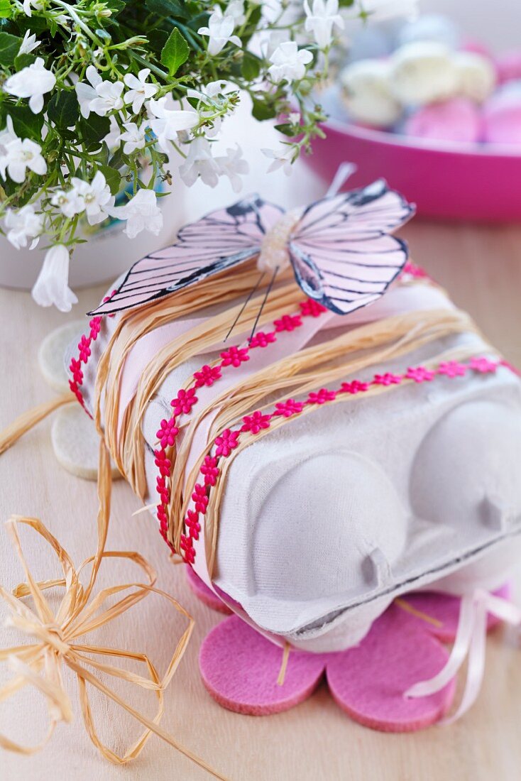 Egg carton used as Easter gift box decorated with ribbons & paper butterfly