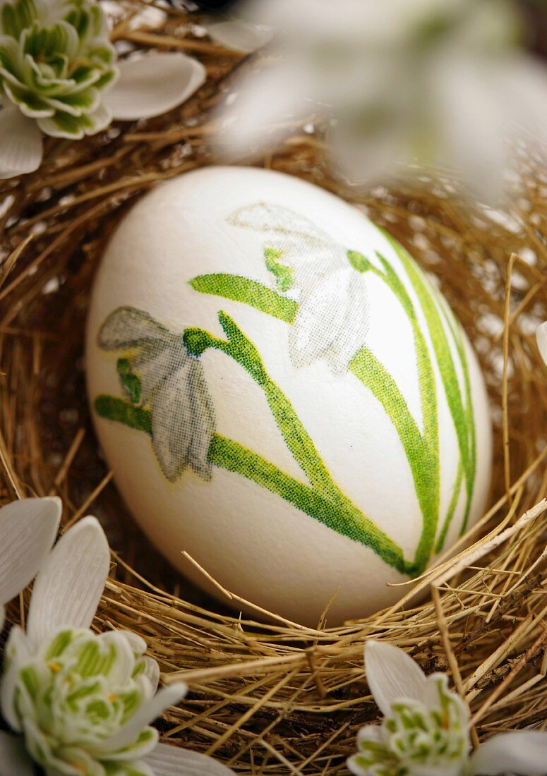 Easter egg decorated with snowdrops using napkin decoupage