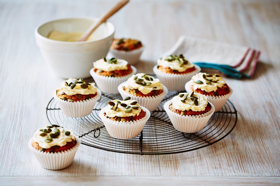 Carrot cupcakes with cream cheese and pumpkin seeds