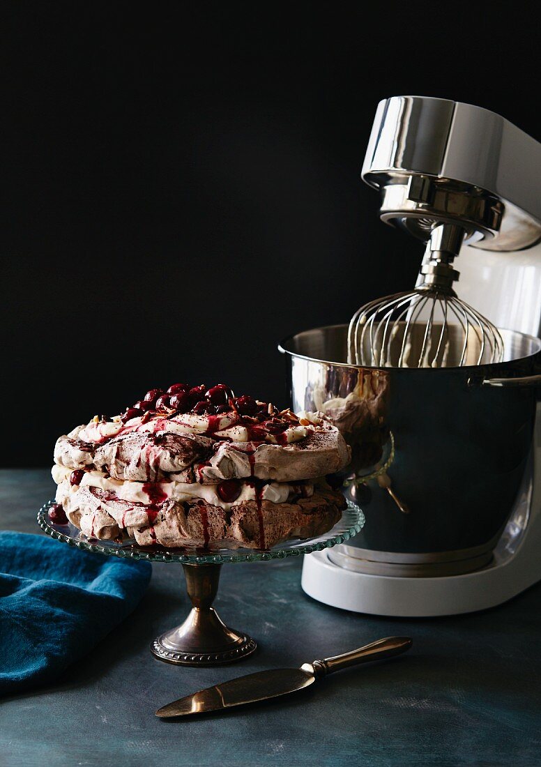 A Pavlova in front of a food processor