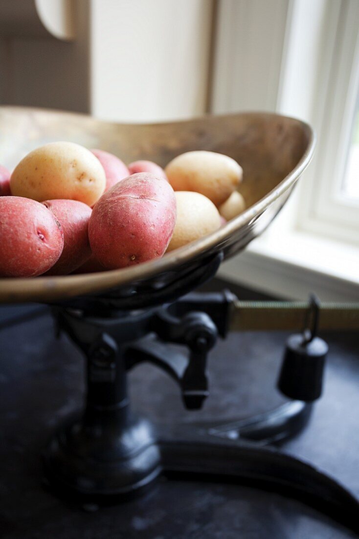 Various potatoes on an old pair of kitchen scales