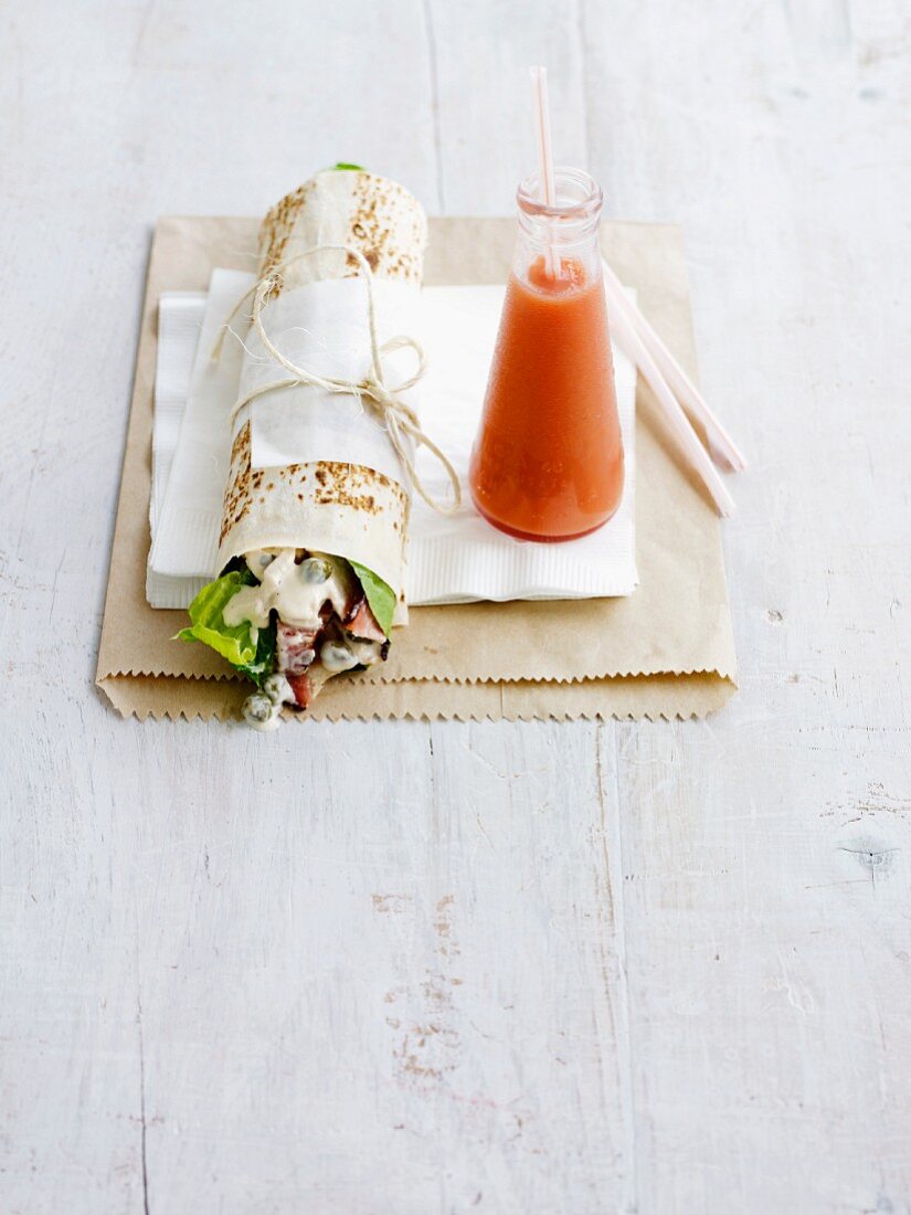 A Caesar wrap with a smoothie