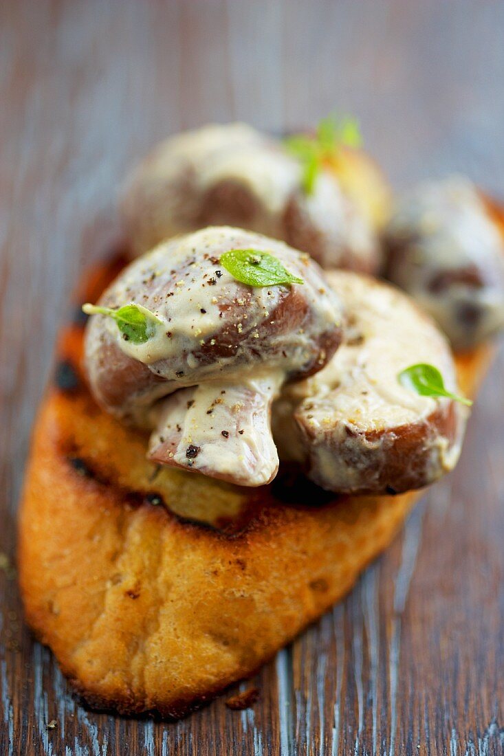 Bruschetta topped with mushrooms and mayonnaise