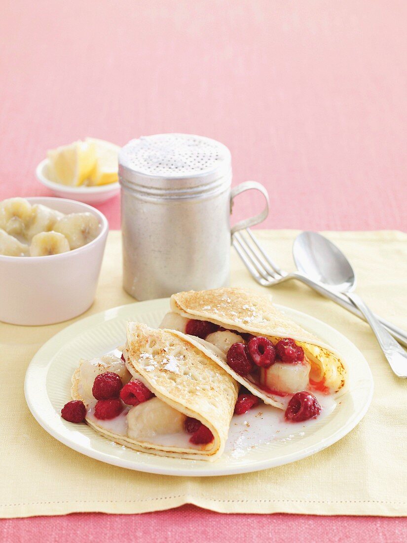 Coconut and banana crepes with raspberries