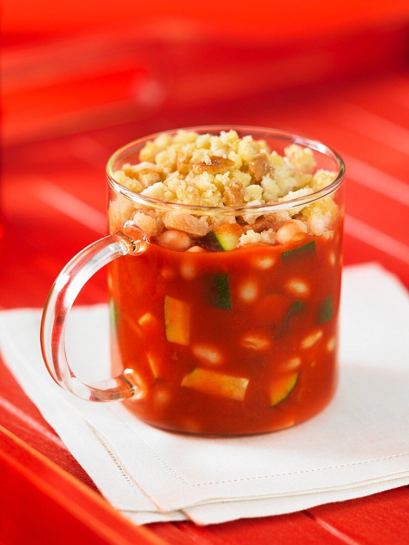 Tomato and courgette crumble in a glass cup