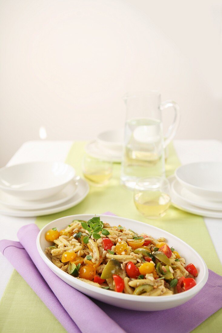 Pasta with colourful tomatoes, oregano and pine nuts
