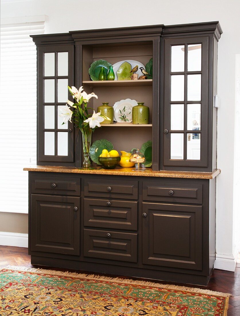 Green ceramic ornaments in old, refurbished, repainted kitchen dresser