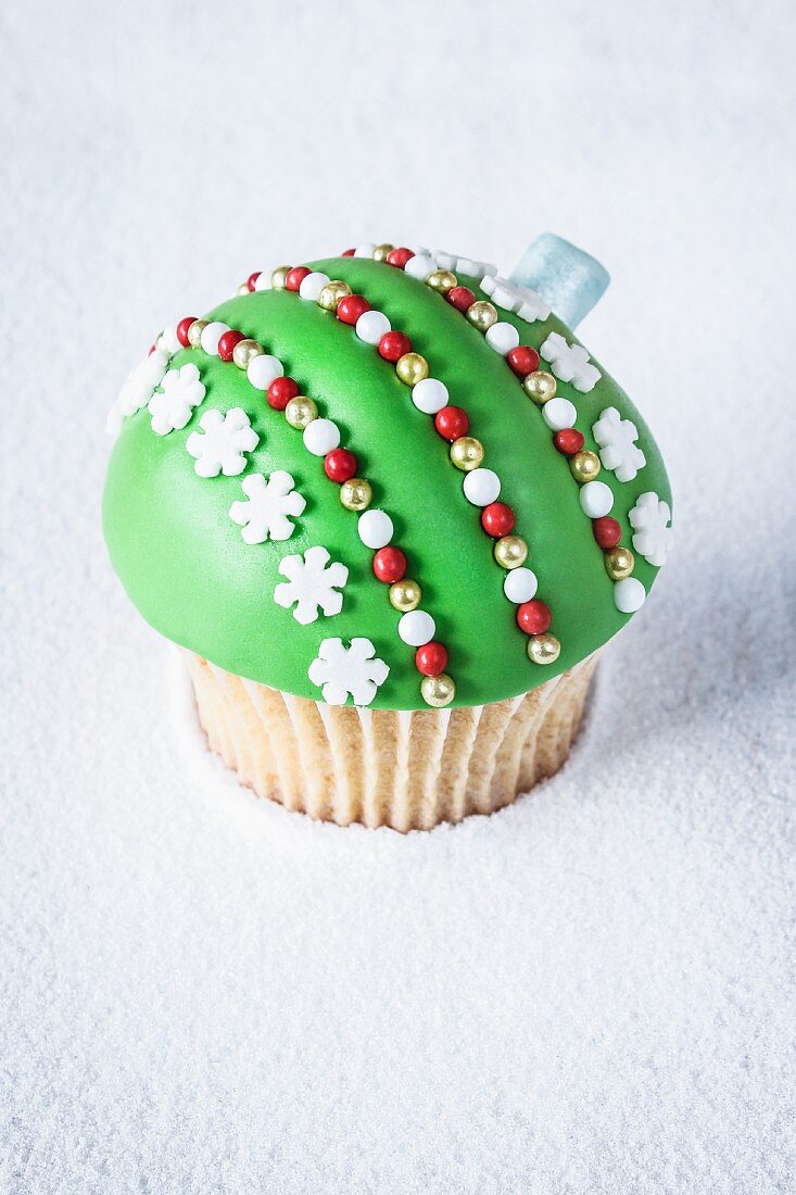 A green Christmas bauble cupcake