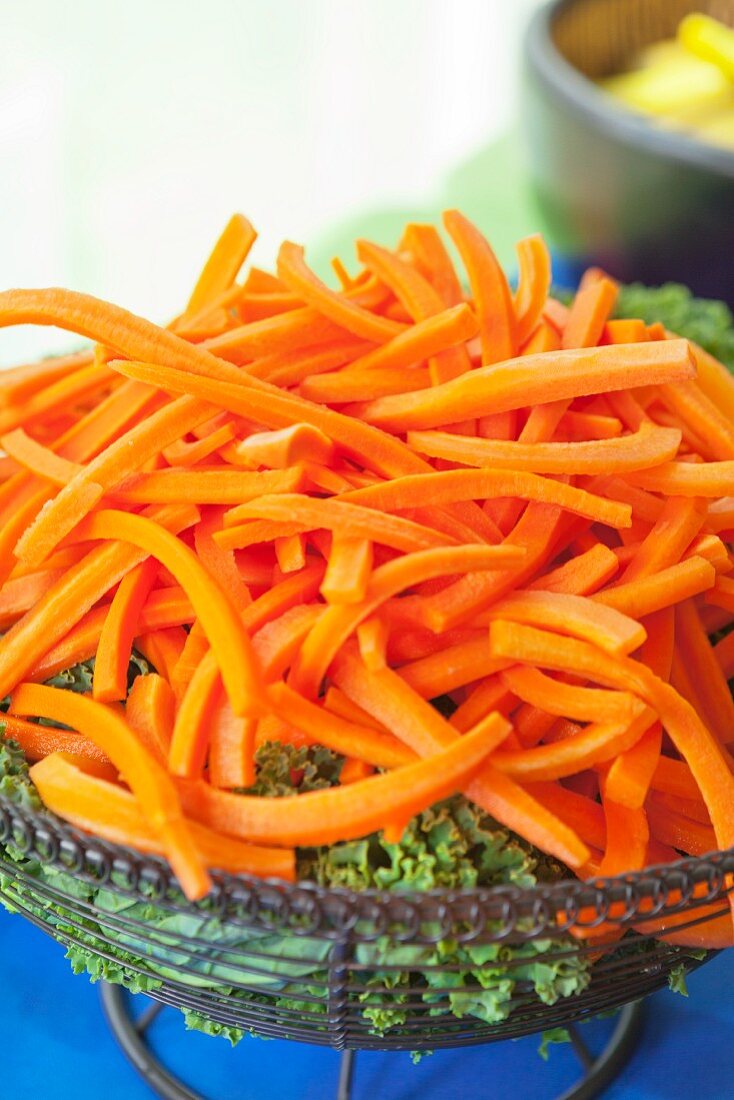 Carrots and kale in a wire basket