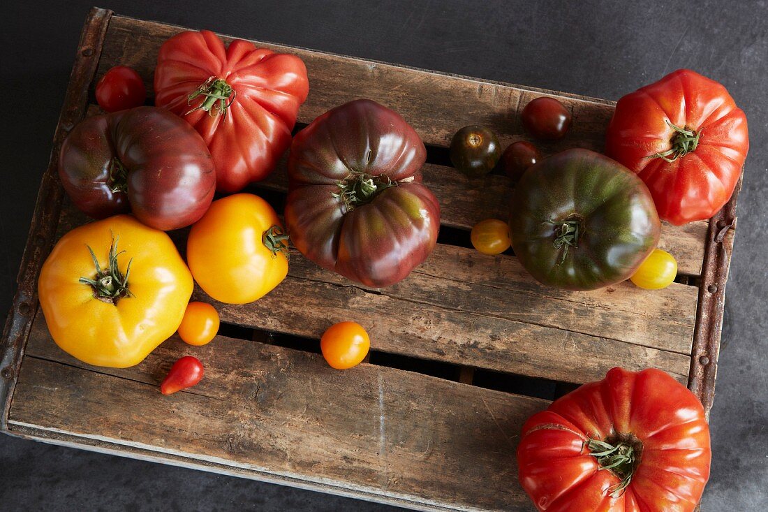 A selection of heirloom tomatoes on a wooden board