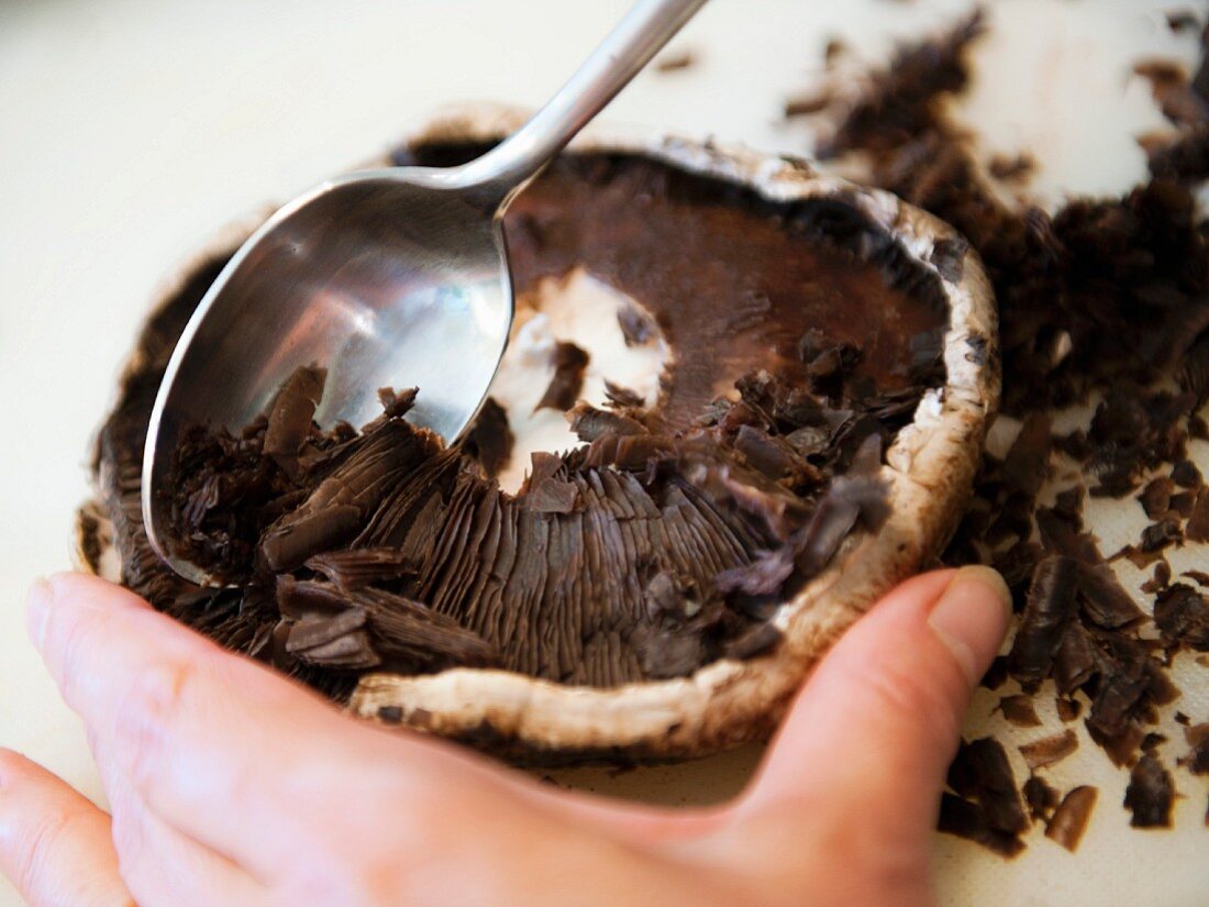 A portobello mushroom being scooped out