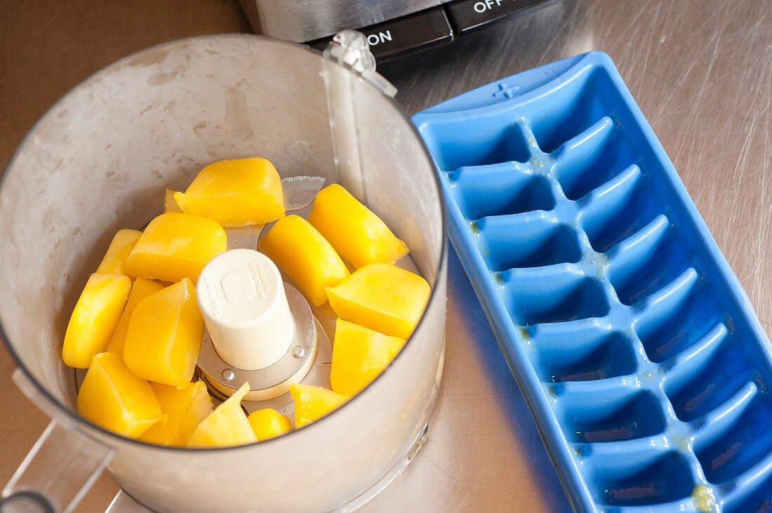 Frozen mango puree in a mixer