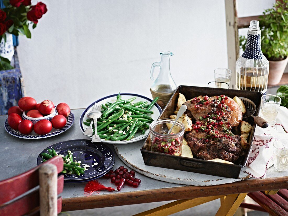 Roast lamb with pomegranate seeds and vegetables for Easter