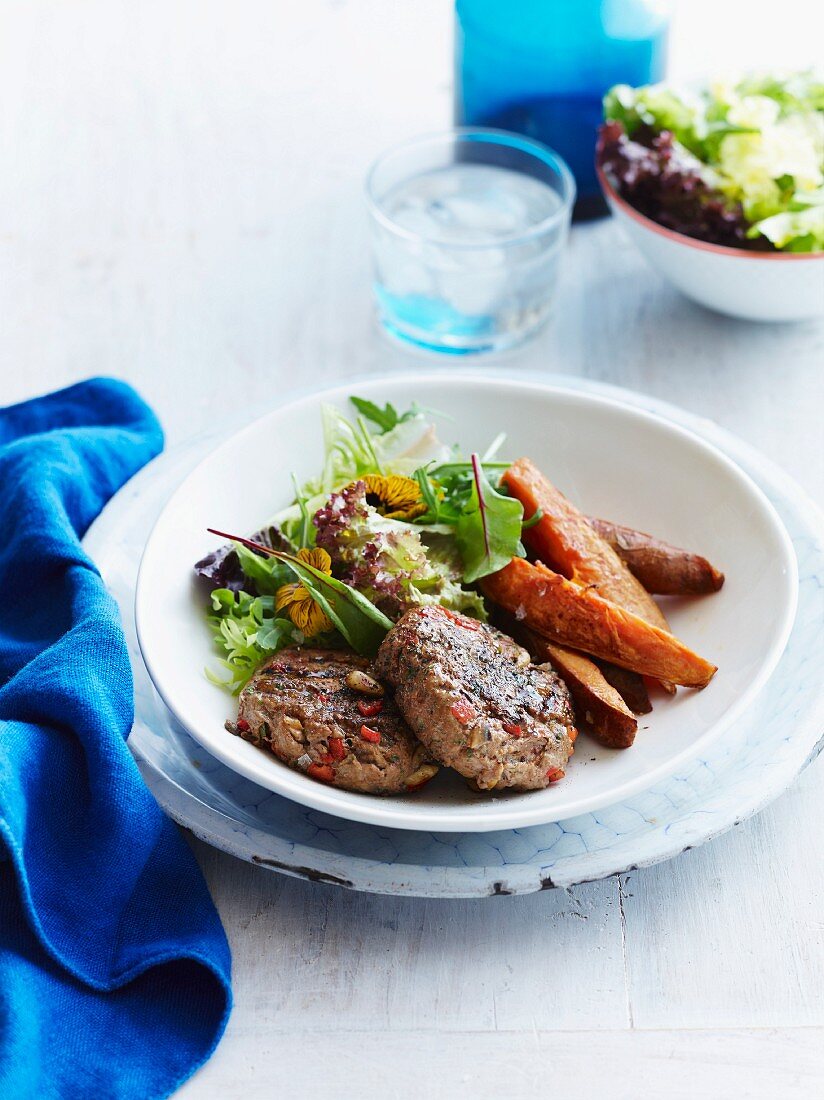 Turkey patties with sweet potatoes and a mixed leaf salad