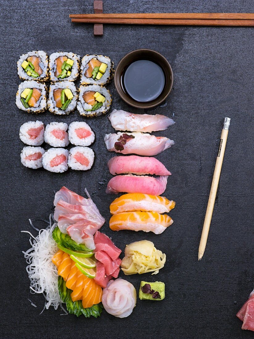 A platter of sushi featuring sashimi, ginger and wasabi